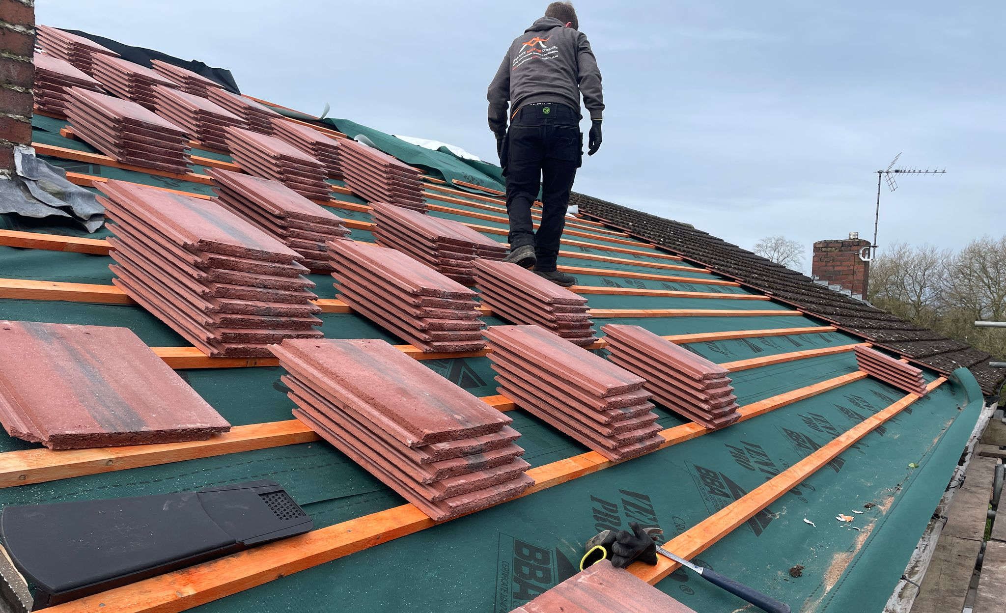 An image of Opulance Roofing Cheshire working on a roof